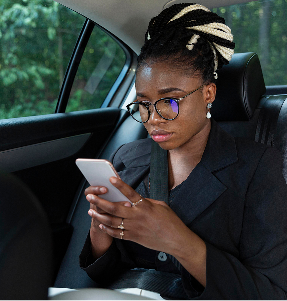 Woman pressing phone in back seat